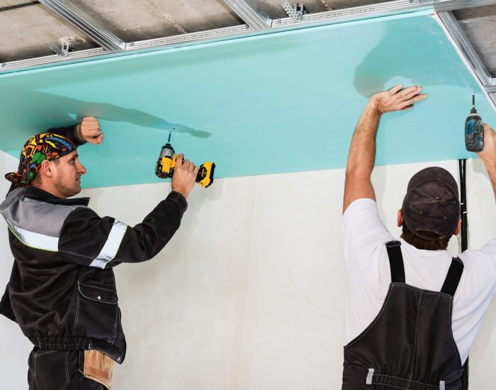 plasterboard-installers-men-assembling-drywall-false-ceiling-simple-affordable-renovation-premises